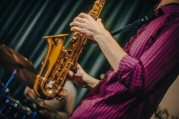 Obraz premium playing the saxophone. performer plays at a concert