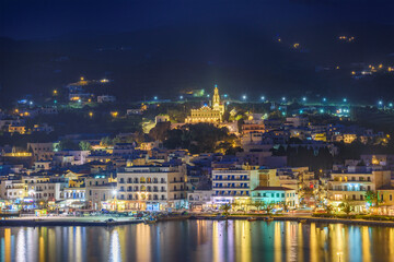 Night long exposure view of Tinos town. Centered the famous church of Panagia, Virgin Mary,...