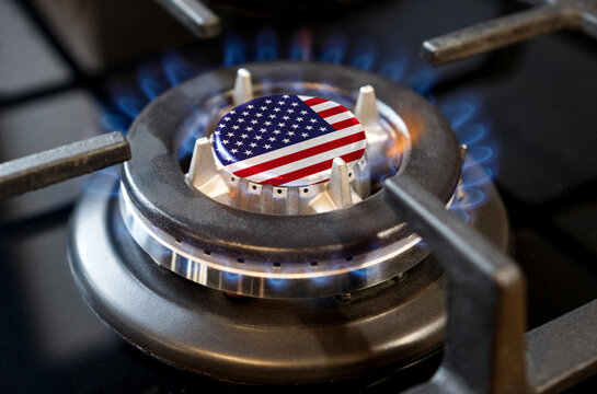 A burning gas burner of a home stove, in the middle of which a flag is depicted - USA