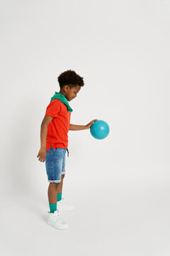 Smiling boy bouncing ball