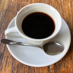 Black Indonesian Luwak Coffee in White Cup with Spoon, Bali