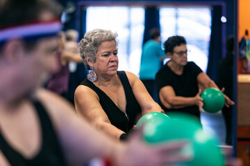 Hispanic Woman Using Exercise Ball To Stretch