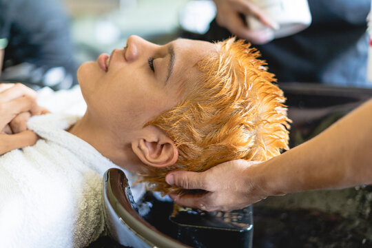 Woman very relaxed while washing her hair.