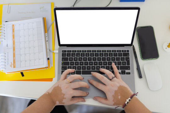 Hands typing on laptop keyboard 