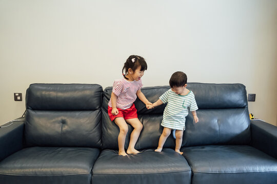 Cute little boy and girl playing at home