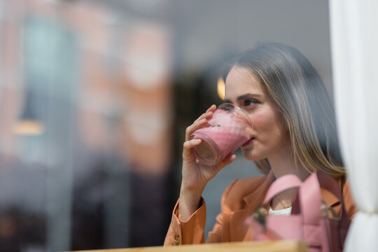 Woman Drinking Pink Latte