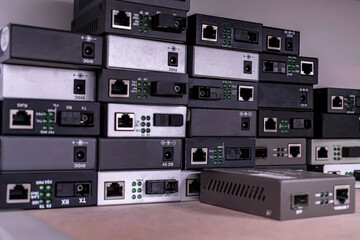 Obraz premium Many media converters are stacked on top of each other. Technological background. selective focus