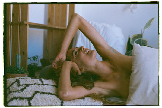 natural woman posing at home with expired film