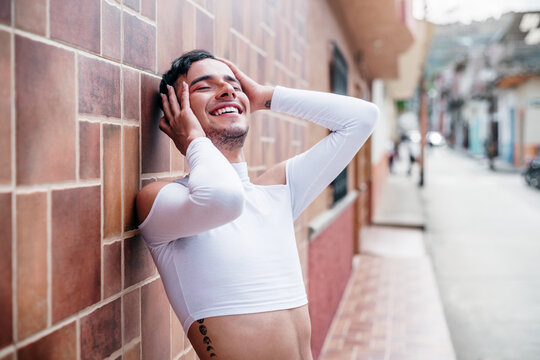 Young man with smiling expression on wall