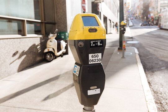 Yellow and black parking meter