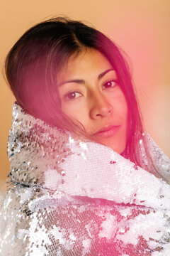 Pretty woman with sequin cape blurred portrait
