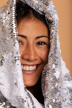 Cheerful woman with sequined veil headshot