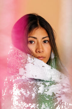 Attractive woman with sequin cape colorful portrait