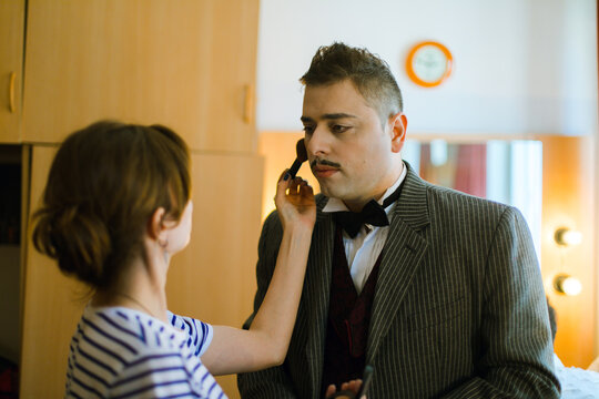 An actor and a make-up artist in front of a mirror