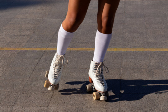Anonymous woman's legs skating on a court