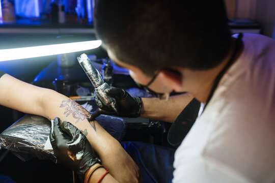 Close-up of tattoing an arm