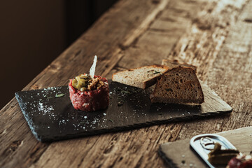 tartare raw beef with bread and wine glass