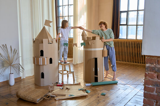 parent and child build cardboard house