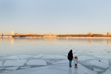 Standing on the ice of a frozen lake