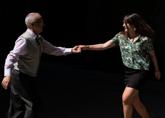 Couple swing dancing.