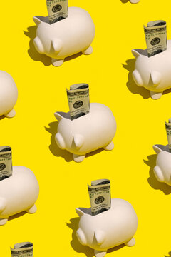 Piggy banks with a hundred dollar cash bill. Savings concept.
