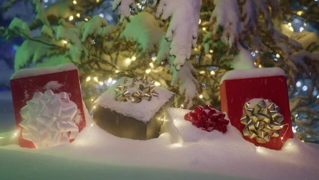 Snowflakes flying in slow motion above Christmas gifts in the magic forest, background for Christmas sale or promo offer. Beautiful scene with gift boxes under snow. Merry Christmas background 6K