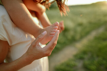 woman's hand and baby's leg
