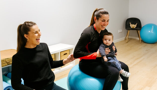 Mother and baby attending a postpartum recovery class
