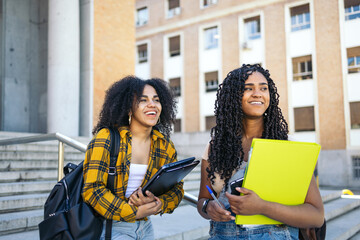 young students talking on the stairs of the university campus