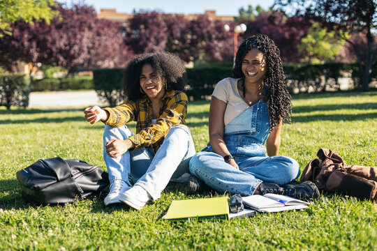 Students sitting on a lawn at the university