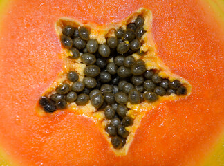 texture details sweet papaya fresh red with black seeds. papaya slice background