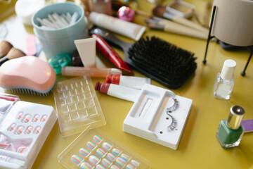 Close up of Cosmetics on a yellow table