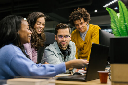 Group Of Colleagues Discussing Their Work In The Office