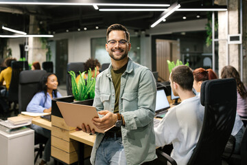 Business Holding A Laptop