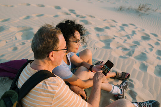 Middle-age couple looking at the smart phone