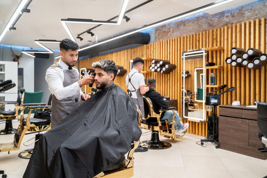 Barbers Working With Their Clients