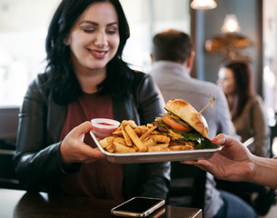 Brewery: Food Server Delivers Hamburger to Woman