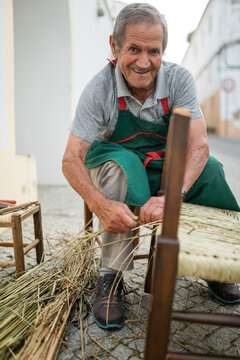 senior craftsman making a chair with bayon