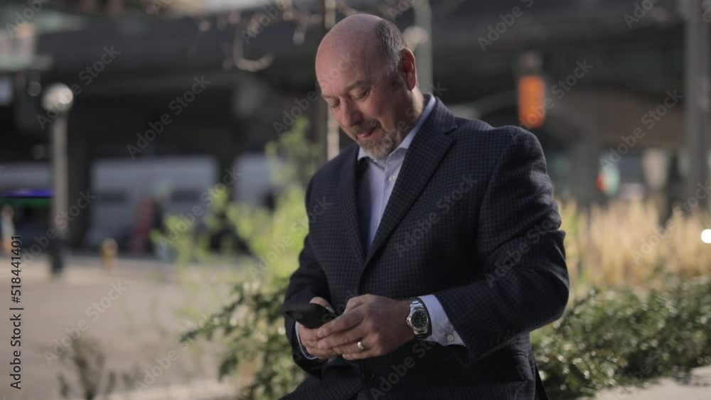 Poster man reading and texting and laughing with blurred background and cars driving by