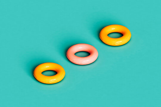 three yellow and pink inflatable rings