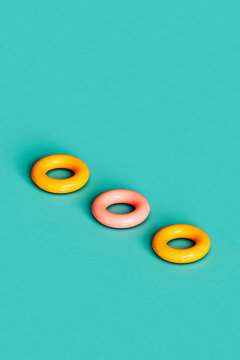 three isometric yellow and pink inflatable rings