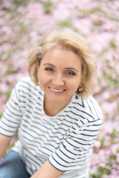 Portrait of middle aged woman in sakura park