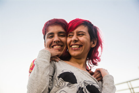 Trans man and non-binary person smiling portrait