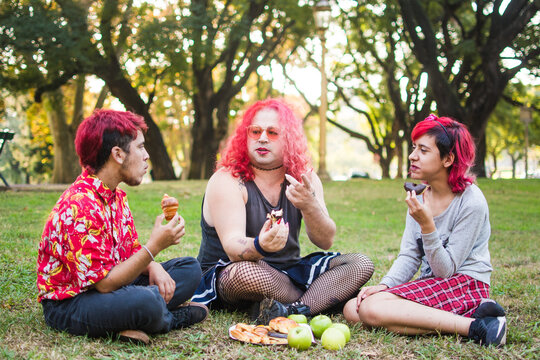 Trans friends eat snacks at the park
