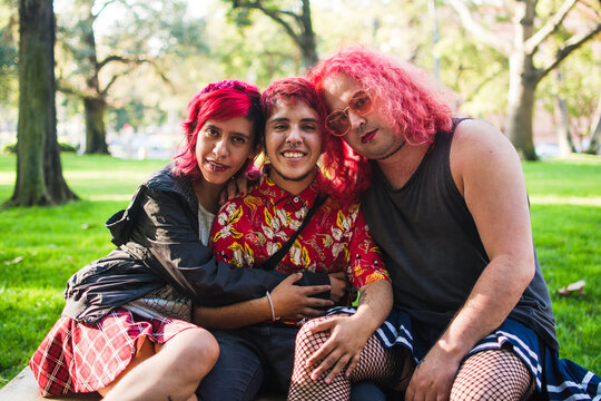 Trans woman, trans man and non binary person hugging each other