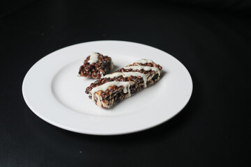 Almond , Raisin and oat protein bars on table 