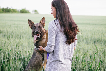 German shepherd dog and woman in coutryside