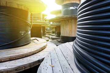 Wooden Coils Of Electric Cable Outdoor. High and low voltage cables in the storage.