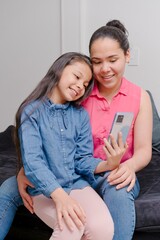 mother and daughter looking at the cell phone