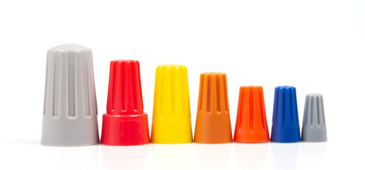 Many colored wire nuts on white background , Tool for connecting electrical wires.